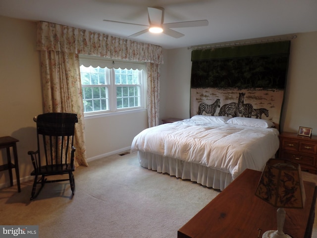 carpeted bedroom featuring baseboards and ceiling fan