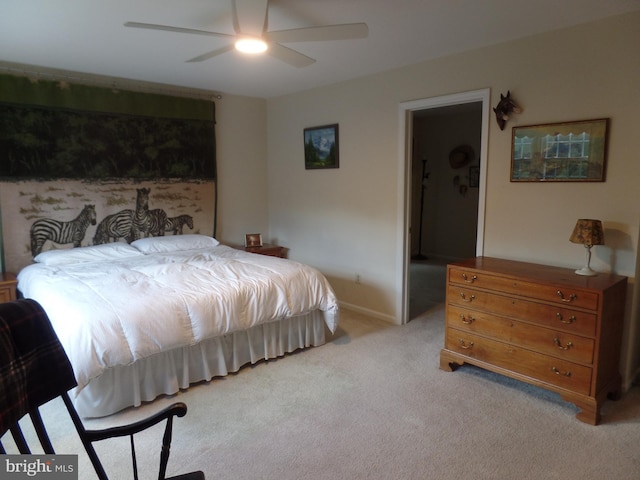 bedroom with light colored carpet, ceiling fan, and baseboards