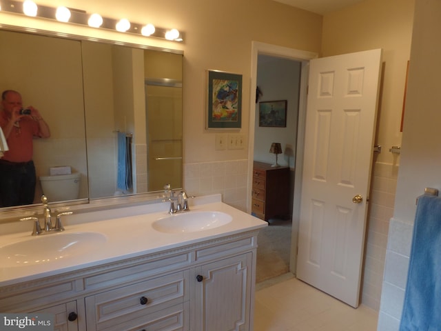 full bathroom featuring double vanity and a shower