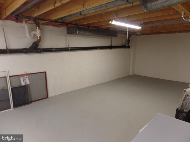 below grade area featuring concrete block wall