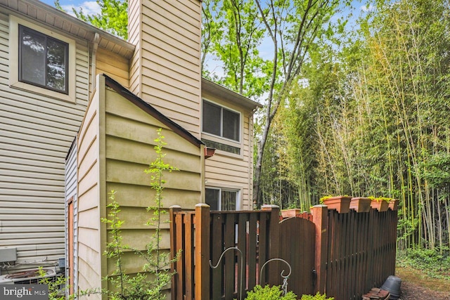 1211 Hesselius Ct, Annapolis, MD 21403 - view of side of home featuring a gate and a chimney