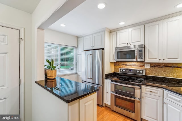 1211 Hesselius Ct, Annapolis, MD 21403 - kitchen featuring appliances with stainless steel finishes, white cabinets, tasteful backsplash, recessed lighting, and light wood finished floors