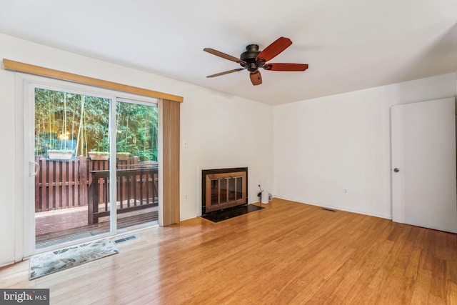 1211 Hesselius Ct, Annapolis, MD 21403 - unfurnished living room featuring light wood-type flooring, a fireplace with flush hearth, and ceiling fan