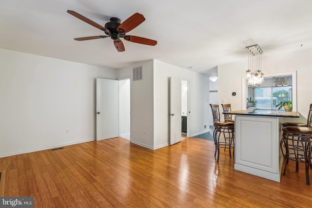 1211 Hesselius Ct, Annapolis, MD 21403 - dining room with ceiling fan, wood finished floors, a chandelier, and baseboards