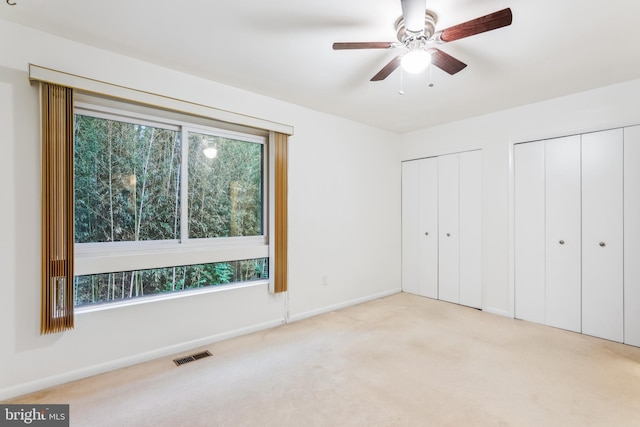 1211 Hesselius Ct, Annapolis, MD 21403 - unfurnished bedroom with two closets, multiple windows, carpet, and baseboards
