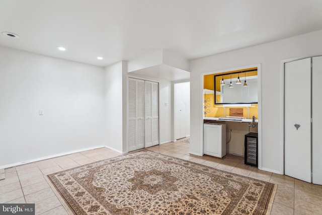 1211 Hesselius Ct, Annapolis, MD 21403 - unfurnished living room featuring light tile patterned floors, beverage cooler, recessed lighting, and baseboards