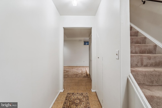 1211 Hesselius Ct, Annapolis, MD 21403 - hallway featuring light tile patterned floors, stairway, and baseboards