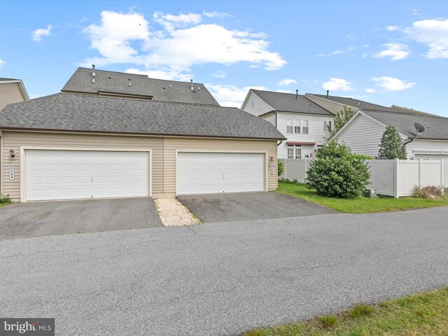 206 Village Center Blvd, Milton, DE 19968 - view of front of home with fence, driveway, and a shingled roof