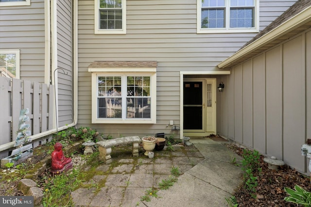 doorway to property with fence and a patio area