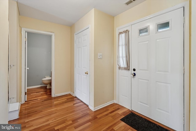 entryway with light wood-style floors and baseboards
