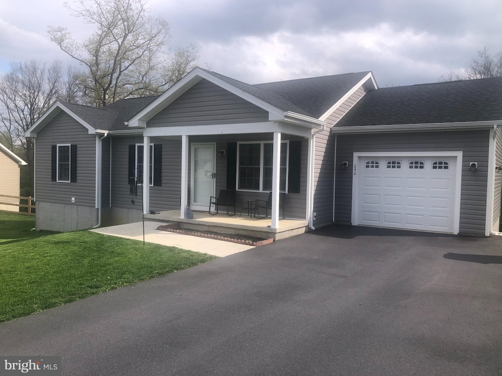246 Hannah Ln, Bunker Hill, WV 25413 - ranch-style home featuring a porch, a garage, asphalt driveway, roof with shingles, and a front yard