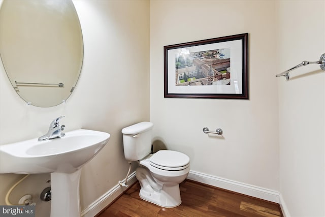 6000 Same Voyage Way Unit 307, Clarksville, MD 21029 - half bathroom with baseboards, toilet, wood finished floors, and a sink