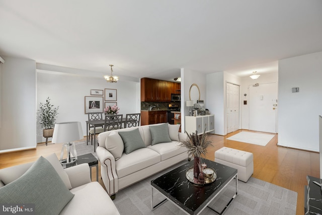 1900 Lyttonsville Rd Unit 1017, Silver Spring, MD 20910 - living area with a notable chandelier and light wood-style floors