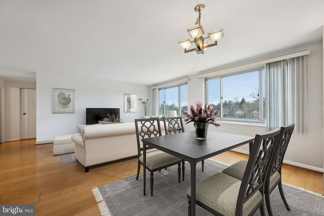 1900 Lyttonsville Rd Unit 1017, Silver Spring, MD 20910 - dining area featuring light wood finished floors, a chandelier, and baseboards