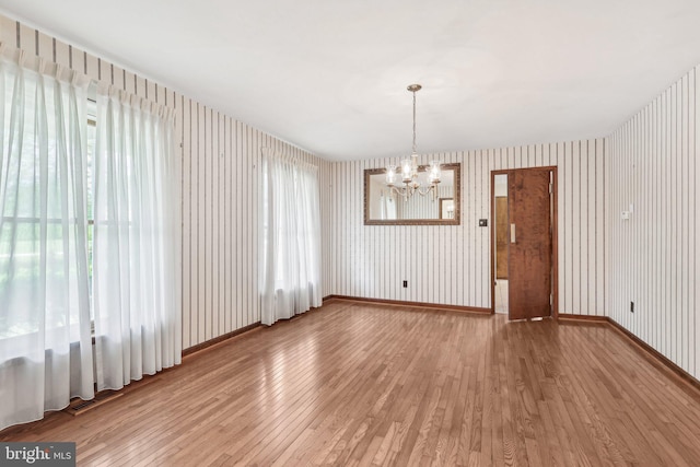 237 Bordentown-Georgetown Rd, Chesterfield, NJ 08515 - unfurnished dining area featuring a chandelier, wallpapered walls, light wood-style floors, and baseboards
