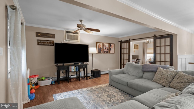 10 Queen Lily Rd, Levittown, PA 19057 - living area with a barn door, crown molding, a ceiling fan, wood finished floors, and a baseboard radiator