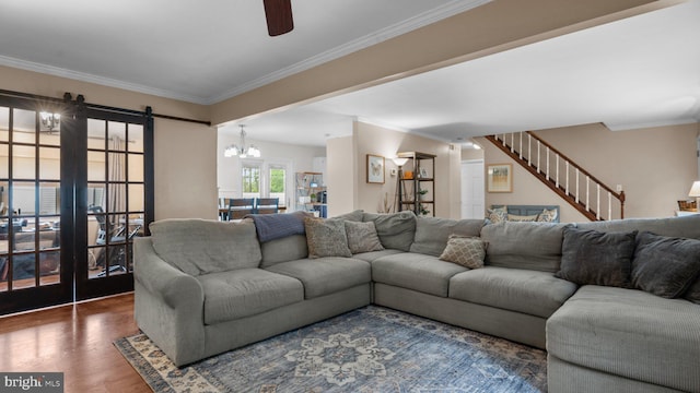 10 Queen Lily Rd, Levittown, PA 19057 - living area with ceiling fan, wood finished floors, crown molding, a chandelier, and a barn door