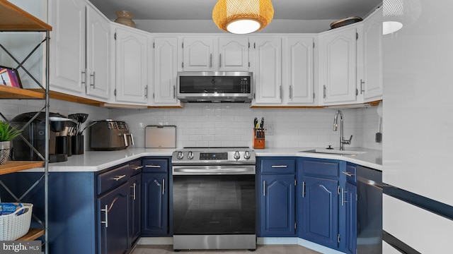 10 Queen Lily Rd, Levittown, PA 19057 - kitchen featuring stainless steel appliances, blue cabinetry, light countertops, and a sink