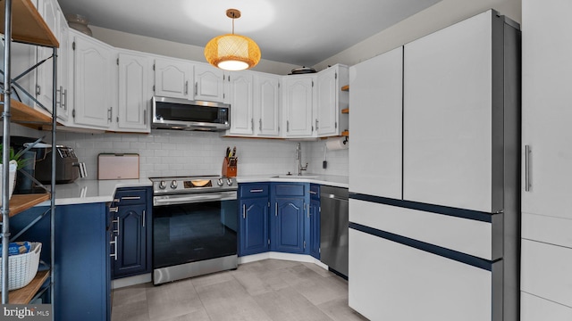 10 Queen Lily Rd, Levittown, PA 19057 - kitchen with appliances with stainless steel finishes, blue cabinetry, a sink, and tasteful backsplash
