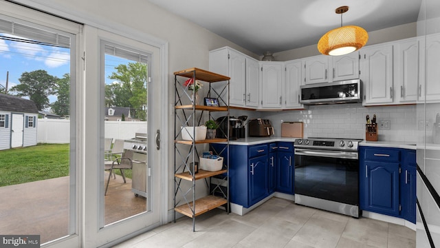 10 Queen Lily Rd, Levittown, PA 19057 - kitchen featuring stainless steel appliances, blue cabinetry, decorative backsplash, and light countertops