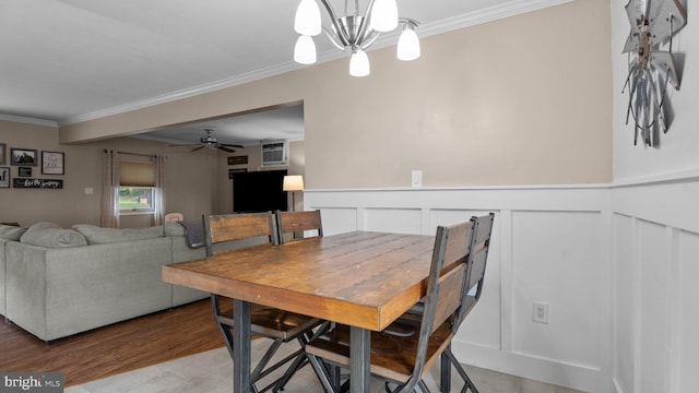 10 Queen Lily Rd, Levittown, PA 19057 - dining area with crown molding, a chandelier, wood finished floors, a decorative wall, and a ceiling fan