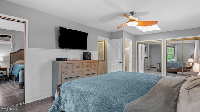 10 Queen Lily Rd, Levittown, PA 19057 - bedroom featuring two closets, dark wood-style floors, a skylight, a wainscoted wall, and a ceiling fan