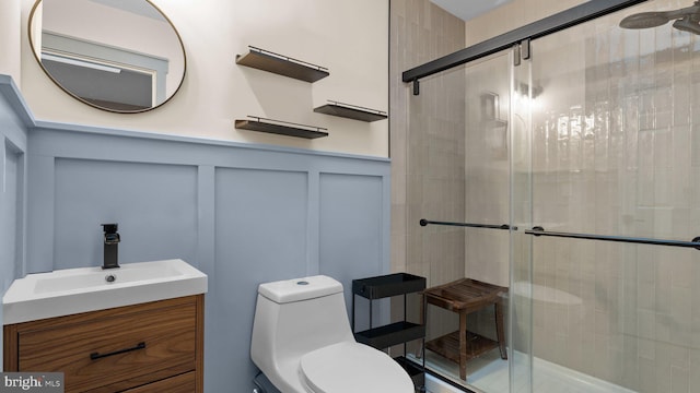 10 Queen Lily Rd, Levittown, PA 19057 - full bath with a decorative wall, a shower stall, vanity, toilet, and wainscoting