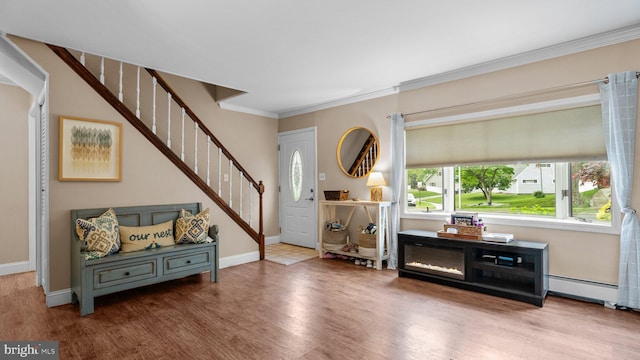 10 Queen Lily Rd, Levittown, PA 19057 - foyer featuring wood finished floors, stairway, ornamental molding, baseboards, and a baseboard heating unit