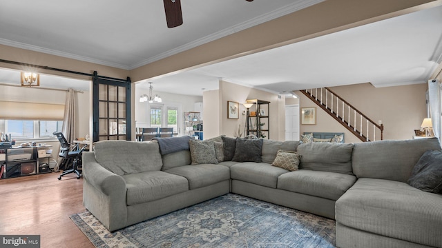 10 Queen Lily Rd, Levittown, PA 19057 - living room featuring ceiling fan, a chandelier, wood finished floors, and ornamental molding