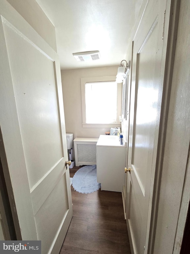 3880 Laurel Grove Rd, Federalsburg, MD 21632 - hall featuring dark wood-type flooring and radiator heating unit