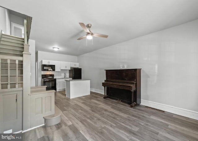 5410 Webster St, Philadelphia, PA 19143 - living room with wood finished floors, visible vents, vaulted ceiling, ceiling fan, and baseboards