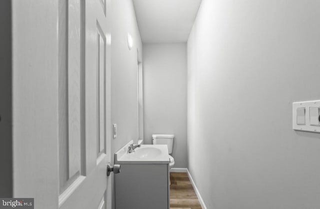 5410 Webster St, Philadelphia, PA 19143 - half bathroom featuring toilet, baseboards, vanity, and wood finished floors