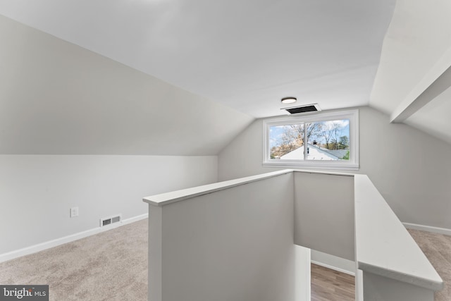 5004 Barnaby Ln, Oxon Hill, MD 20745 - additional living space with lofted ceiling, light carpet, and visible vents