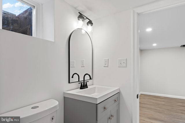 5004 Barnaby Ln, Oxon Hill, MD 20745 - half bathroom with toilet, wood finished floors, vanity, recessed lighting, and baseboards