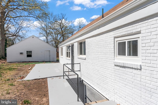 5004 Barnaby Ln, Oxon Hill, MD 20745 - view of side of property featuring a patio area and brick siding