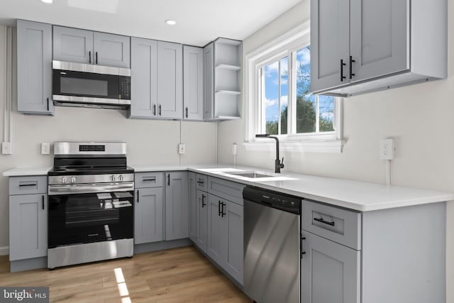 5004 Barnaby Ln, Oxon Hill, MD 20745 - kitchen with a sink, recessed lighting, light countertops, gray cabinetry, and appliances with stainless steel finishes