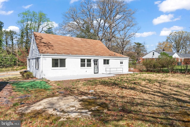 5004 Barnaby Ln, Oxon Hill, MD 20745 - back of property with a lawn, brick siding, and fence