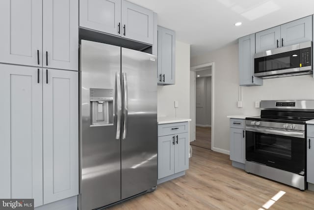 5004 Barnaby Ln, Oxon Hill, MD 20745 - kitchen with stainless steel appliances, recessed lighting, light wood finished floors, light countertops, and baseboards