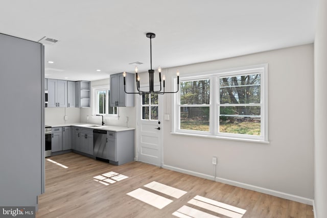 5004 Barnaby Ln, Oxon Hill, MD 20745 - kitchen featuring gray cabinets, stainless steel dishwasher, open shelves, an inviting chandelier, and stove