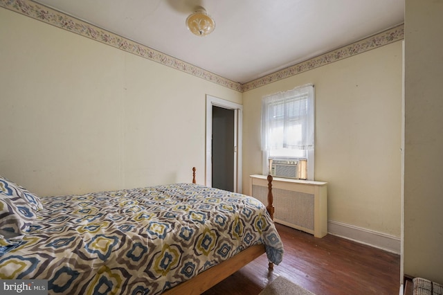 135 Pine St, Dover, DE 19901 - bedroom with radiator, wood finished floors, cooling unit, and baseboards