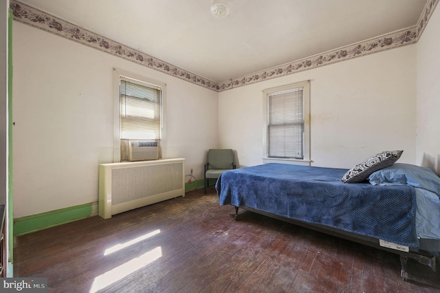 135 Pine St, Dover, DE 19901 - bedroom with radiator, wood-type flooring, baseboards, and cooling unit