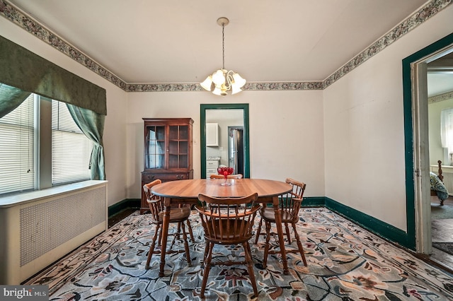 135 Pine St, Dover, DE 19901 - dining area featuring radiator, baseboards, and a chandelier