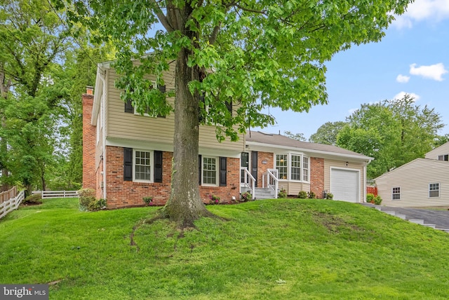 view of front facade with an attached garage, brick siding, a chimney, and driveway