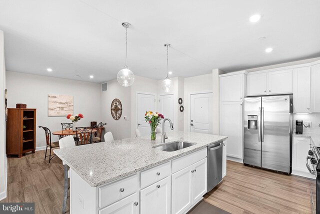 3927 Fair Ridge Dr Unit 305, Fairfax, VA 22033 - kitchen with stainless steel appliances, a sink, light wood-style floors, white cabinets, and recessed lighting