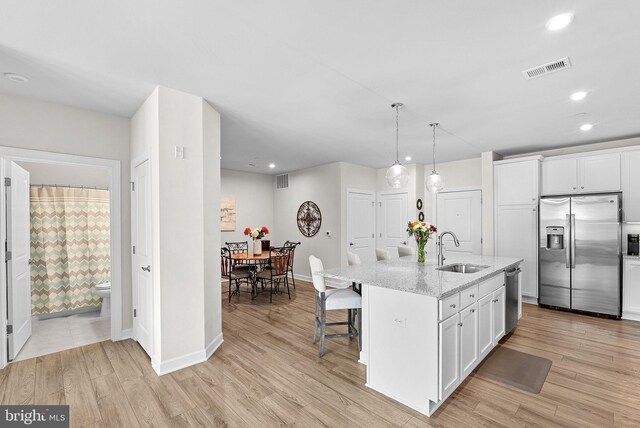 3927 Fair Ridge Dr Unit 305, Fairfax, VA 22033 - kitchen with appliances with stainless steel finishes, a sink, recessed lighting, white cabinets, and light stone countertops