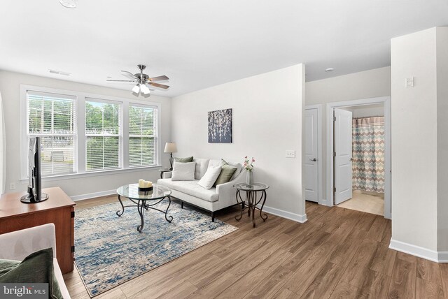 3927 Fair Ridge Dr Unit 305, Fairfax, VA 22033 - living room featuring wood finished floors, a ceiling fan, and baseboards