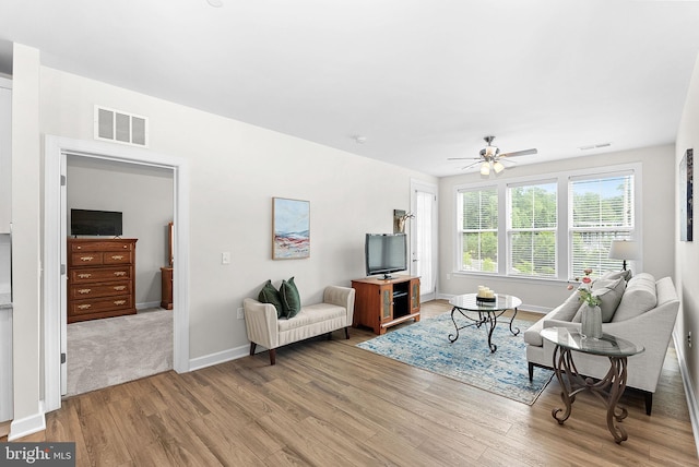 3927 Fair Ridge Dr Unit 305, Fairfax, VA 22033 - living room with light wood finished floors, ceiling fan, and baseboards