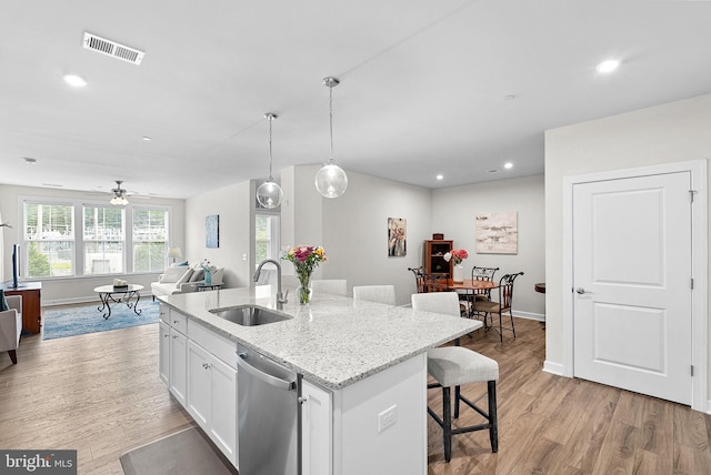 3927 Fair Ridge Dr Unit 305, Fairfax, VA 22033 - kitchen featuring a sink, dishwasher, open floor plan, light wood-style floors, and white cabinetry