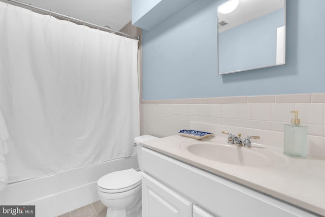 4152 Windy Hills Ln, King George, VA 22485 - full bathroom with vanity, toilet, shower / bath combo with shower curtain, tile walls, and wainscoting
