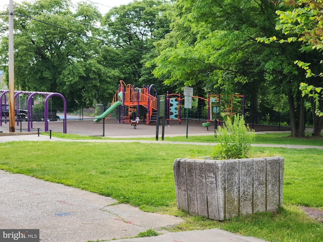community play area with fence and a lawn